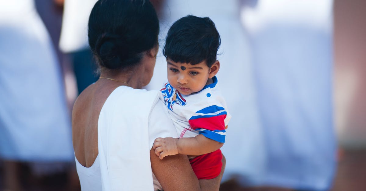 Can a non-parent file for OCI or Indian visa for non-Indian child? - Selective Focus Photography of Woman Holding Child Can a non-parent file for OCI or Indian visa for non-Indian child? - Selective Focus Photography of Woman Holding Child