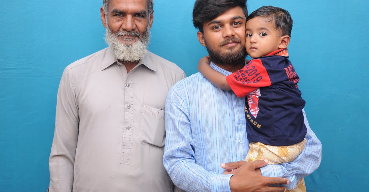 Can a non-parent file for OCI or Indian visa for non-Indian child? - Man in Beige Shirt Standing Beside Man in Blue Shirt Carrying Boy in Navy T-Shirt Can a non-parent file for OCI or Indian visa for non-Indian child? - Man in Beige Shirt Standing Beside Man in Blue Shirt Carrying Boy in Navy T-Shirt