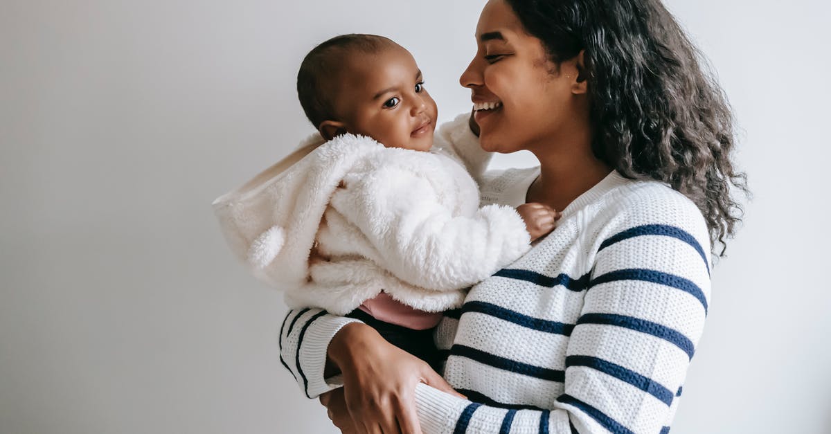Can a non-parent file for OCI or Indian visa for non-Indian child? - Indian mother hugging baby while holding in arms at home Can a non-parent file for OCI or Indian visa for non-Indian child? - Indian mother hugging baby while holding in arms at home