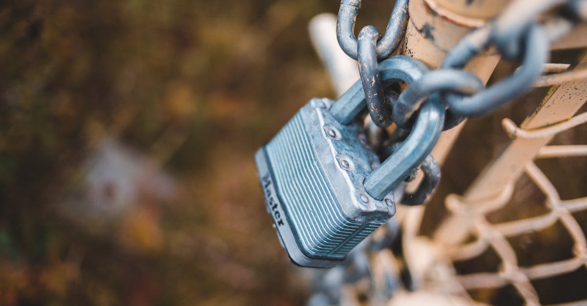 can a pilot refuel his small private airplane internationally without passing immigration or customs? [closed] - From above of small metal lock on chain attached to shabby net mesh fence in autumn park
