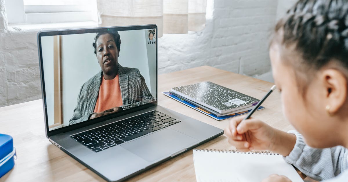 Can a proctored online COVID antigen test be used to travel to the Netherlands? - Back view of crop anonymous focused ethnic girl having exam with tutor through internet on netbook