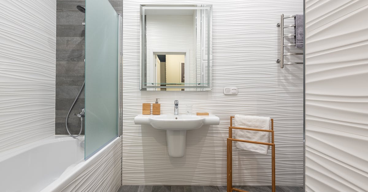 Can a shower hose be taken on planes worldwide without hassle? - Contemporary bathroom interior with bathtub and washstand with toiletry products under mirror in light house Can a shower hose be taken on planes worldwide without hassle? - Contemporary bathroom interior with bathtub and washstand with toiletry products under mirror in light house
