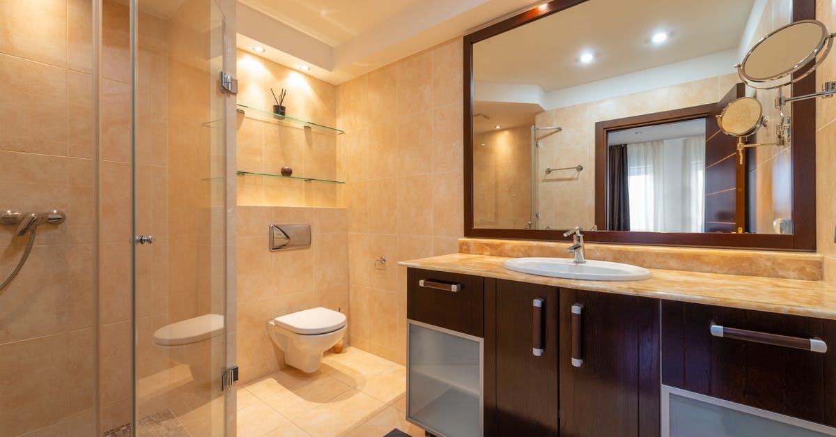 Can a shower hose be taken on planes worldwide without hassle? - Shower room against toilet bowl and cabinet with washbasin under mirrors illuminated by shiny lamps in modern house Can a shower hose be taken on planes worldwide without hassle? - Shower room against toilet bowl and cabinet with washbasin under mirrors illuminated by shiny lamps in modern house