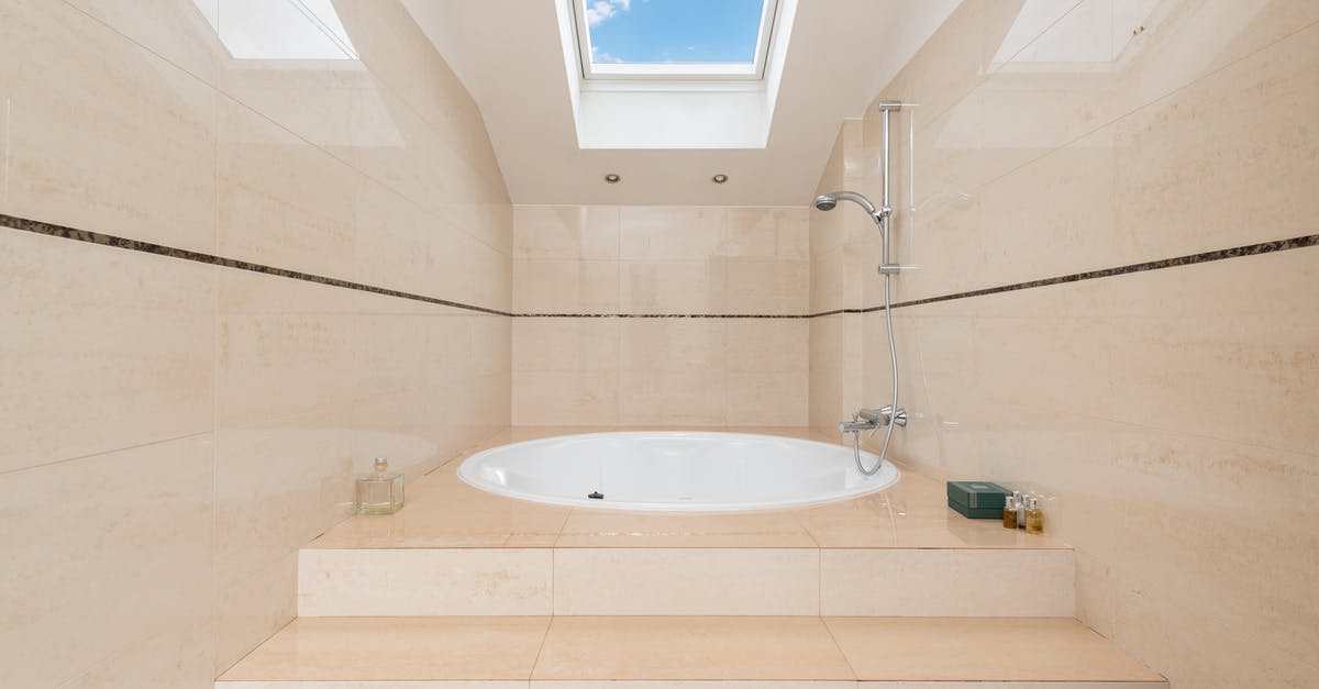 Can a shower hose be taken on planes worldwide without hassle? - Modern bathroom interior with bath under window at home Can a shower hose be taken on planes worldwide without hassle? - Modern bathroom interior with bath under window at home