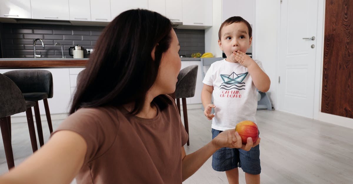 Can a son in Kuwait sponsor his mom in India for a UK visitor visa? - Girl in Brown T-shirt Holding Blue Ball