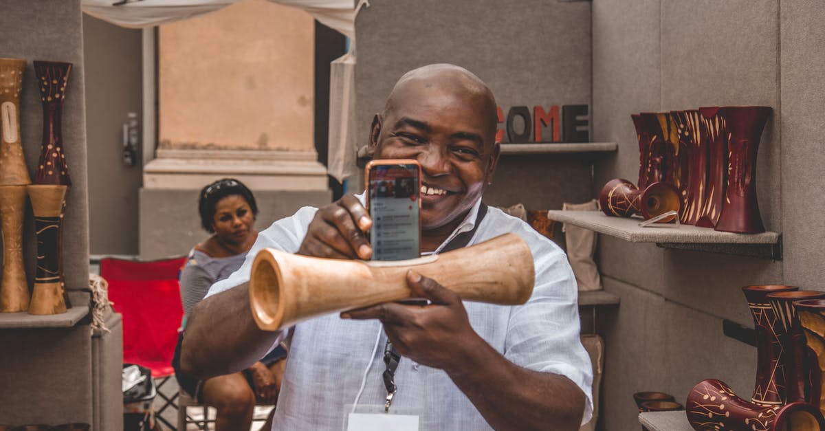 Can a South African apply for a work Z visa in Hong Kong? [closed] - Man Taking Photo of Brown Decorative Speaker