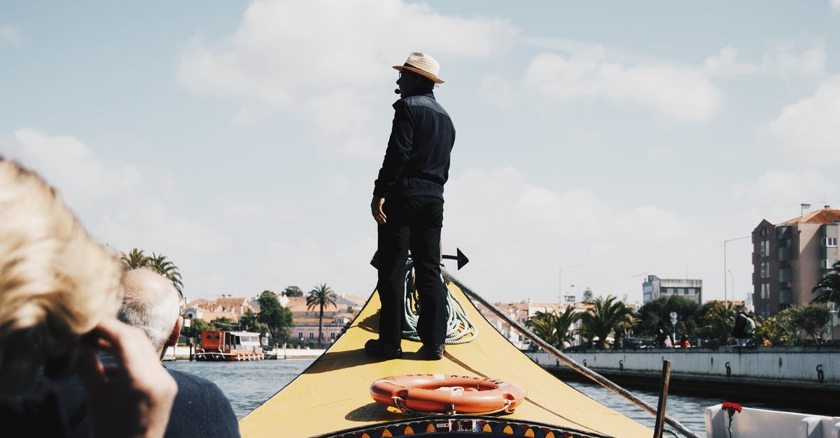 Can a visit on ESTA jeopardize getting my J-1 for a summer job? [closed] - Black man standing on tourists boat front