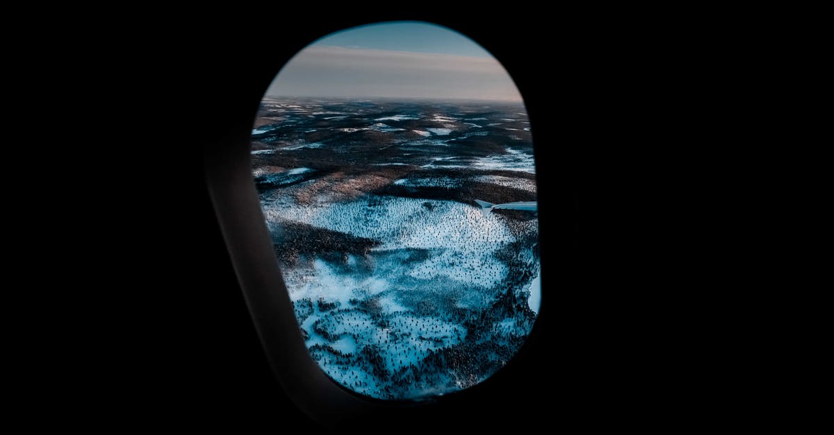 Can an airline change a reservation booked through Expedia? - Through aircraft window of picturesque mountainous valley covered with snow under cloudy sunset sky Can an airline change a reservation booked through Expedia? - Through aircraft window of picturesque mountainous valley covered with snow under cloudy sunset sky