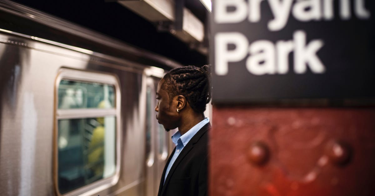 Can an American get a UK Transit Visa on Arrival? - Side view of smart African American male with cellphone in hand waiting for arriving subway train to stop Can an American get a UK Transit Visa on Arrival? - Side view of smart African American male with cellphone in hand waiting for arriving subway train to stop