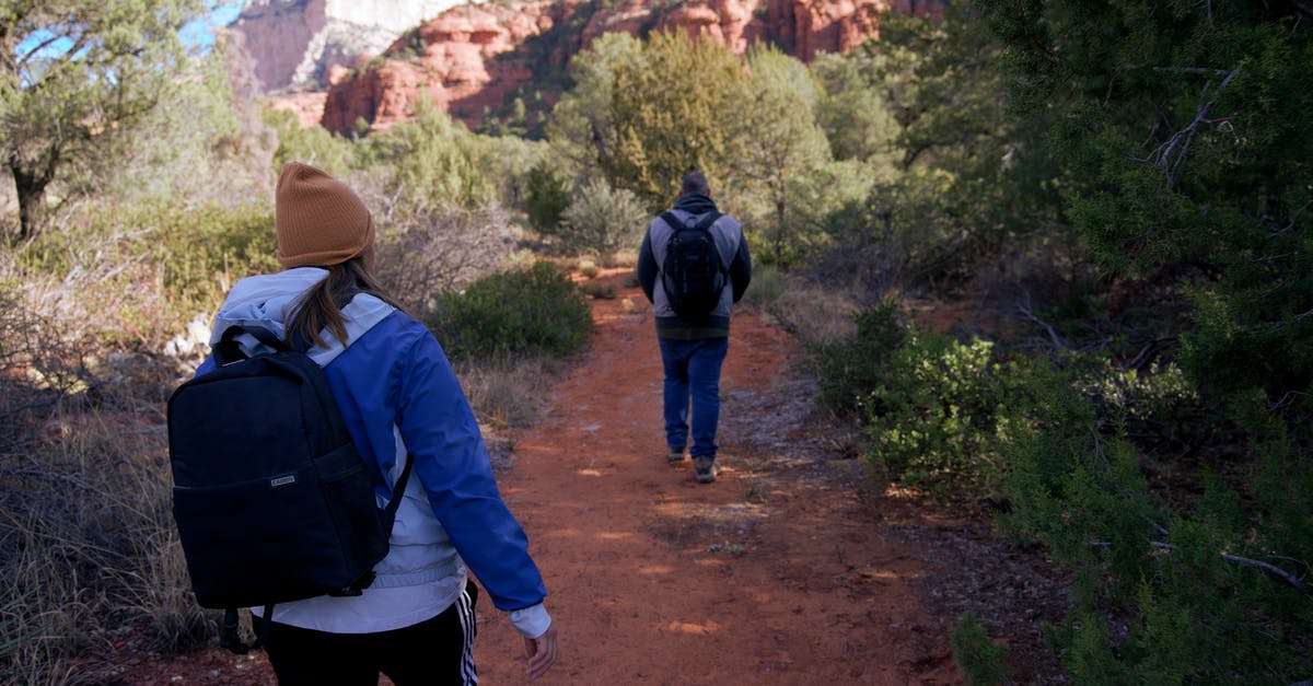 Can anyone recommend a good hiking trail in Scotland? - Man in Blue Jacket and Black Backpack Walking on Dirt Road Can anyone recommend a good hiking trail in Scotland? - Man in Blue Jacket and Black Backpack Walking on Dirt Road