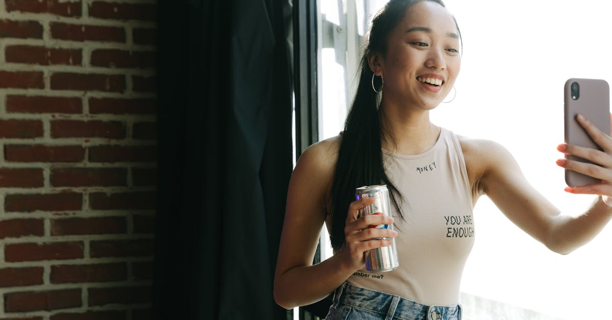 Can be a particular visa required for recording a song? [closed] - 
A Vlogger in a Tank Top Using Her Smartphone