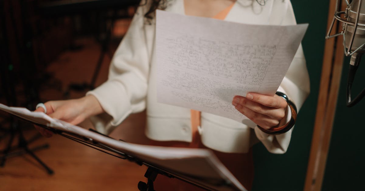 Can be a particular visa required for recording a song? [closed] - Close-Up Shot of an Artist Holding a Paper