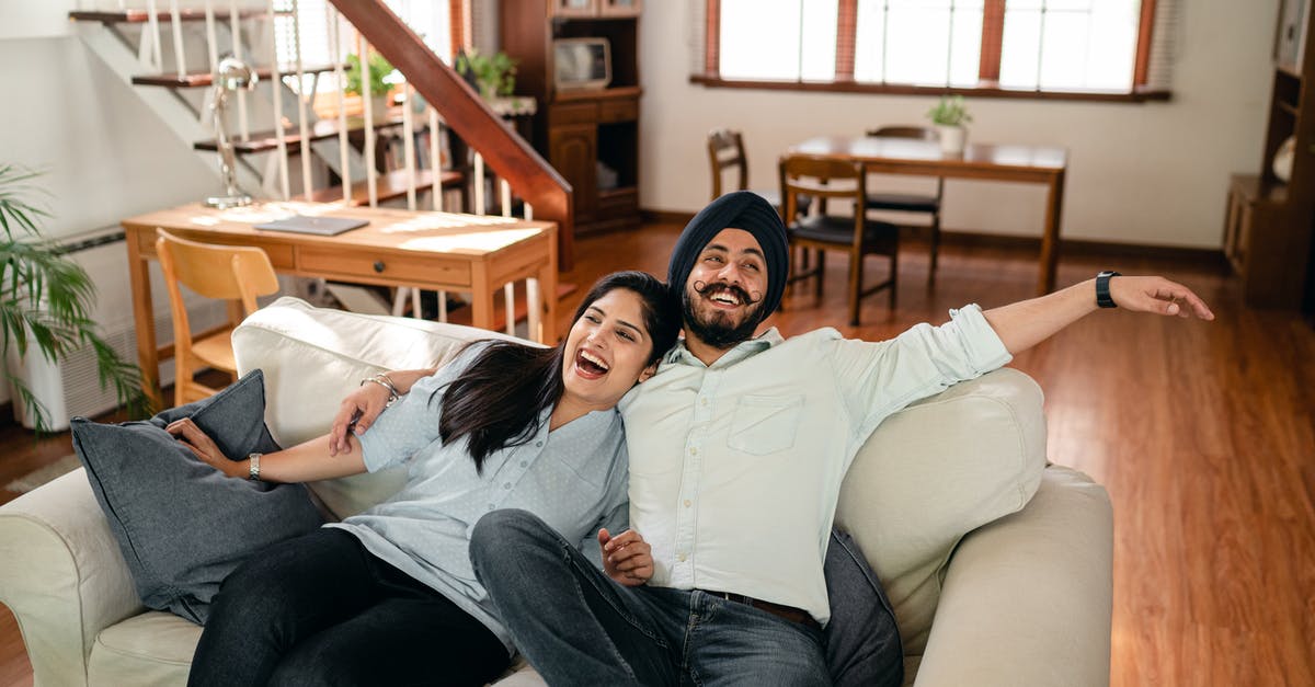 Can having a second wife affect my Australian visa processing/stay? - From above of cheerful young Indian couple in casual wear laughing and hugging each other while relaxing on cozy sofa in contemporary living room Can having a second wife affect my Australian visa processing/stay? - From above of cheerful young Indian couple in casual wear laughing and hugging each other while relaxing on cozy sofa in contemporary living room