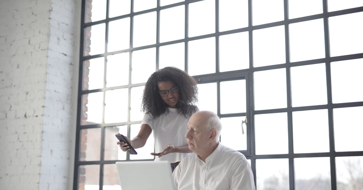 Can I ask to watch a TSA officer put on gloves? - Multiracial businesspeople of different ages using gadgets while working together in creative workplace Can I ask to watch a TSA officer put on gloves? - Multiracial businesspeople of different ages using gadgets while working together in creative workplace