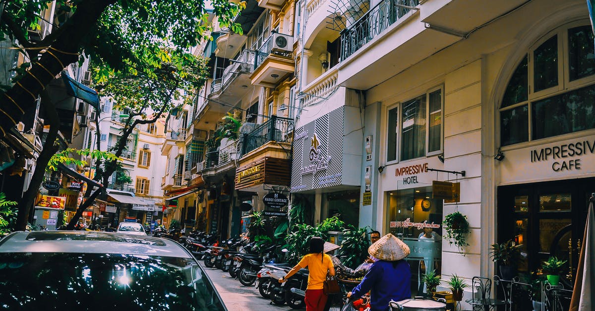 Can I attend a conference on a tourist visa in Vietnam? - People Walking in Front of Buildings Can I attend a conference on a tourist visa in Vietnam? - People Walking in Front of Buildings