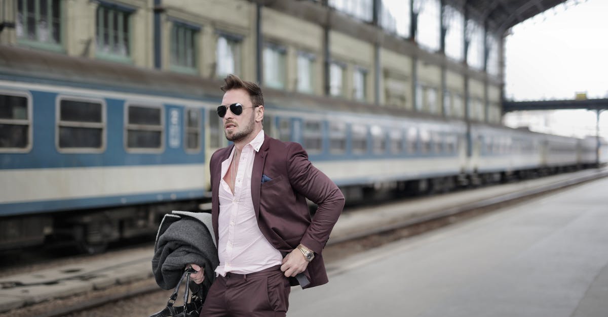 Can I bag wrap my suitcase at Leeds railway station? - Confident trendy male traveler in sunglasses standing on platform on railway station Can I bag wrap my suitcase at Leeds railway station? - Confident trendy male traveler in sunglasses standing on platform on railway station