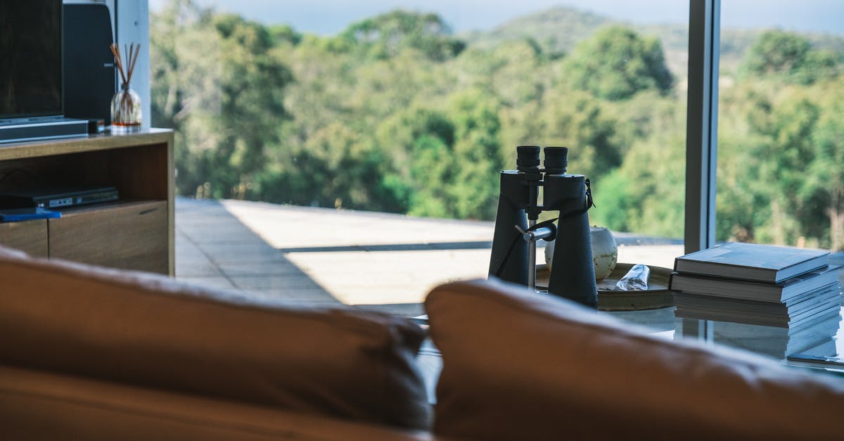 Can I book a different accommodation after receiving my US visa? - Binocular placed near books on table in modern apartment Can I book a different accommodation after receiving my US visa? - Binocular placed near books on table in modern apartment