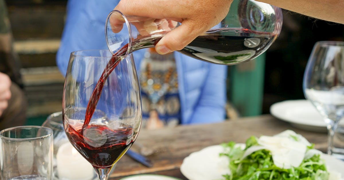 Can I bring a 1-litre bottle of alcohol as a duty-free item to Japan? - Person Pouring Red Wine on Wine Glass