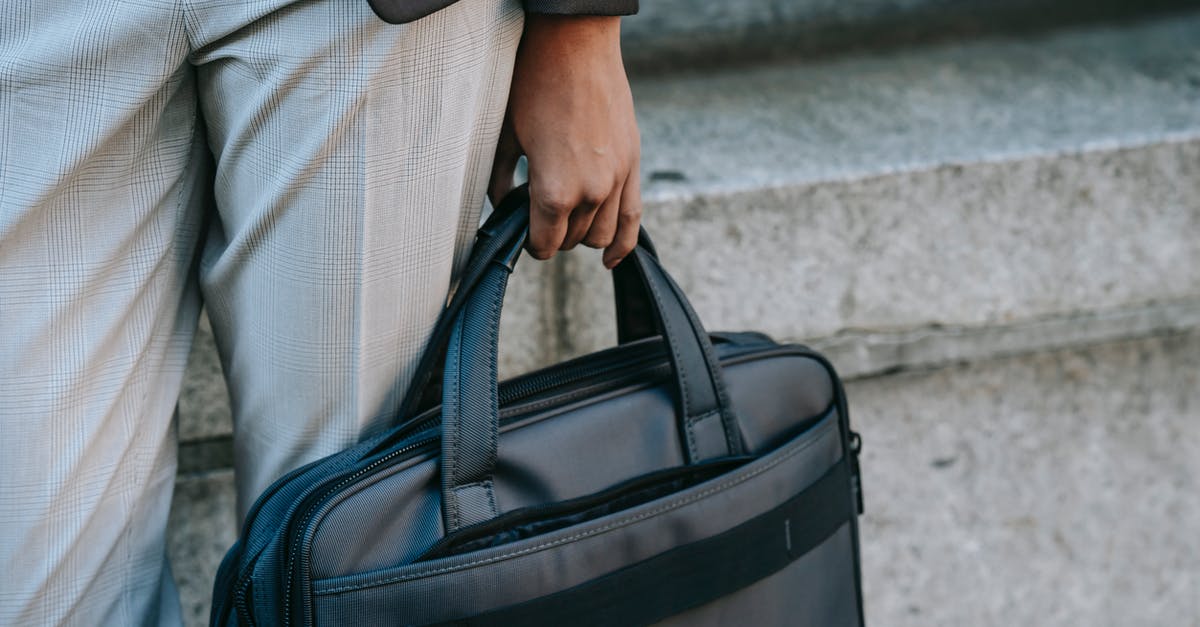 Can I bring a shoebox PC in my carry-on bag? - Crop entrepreneur with laptop in bag Can I bring a shoebox PC in my carry-on bag? - Crop entrepreneur with laptop in bag