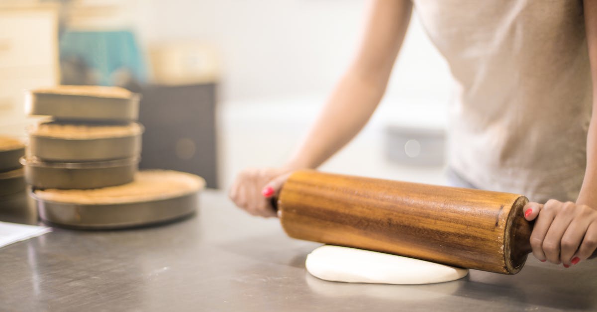 Can I bring a wooden dough rolling stick onto the plane(carry-on)? - Person in White T-shirt Rolling a Pin in Dough Can I bring a wooden dough rolling stick onto the plane(carry-on)? - Person in White T-shirt Rolling a Pin in Dough