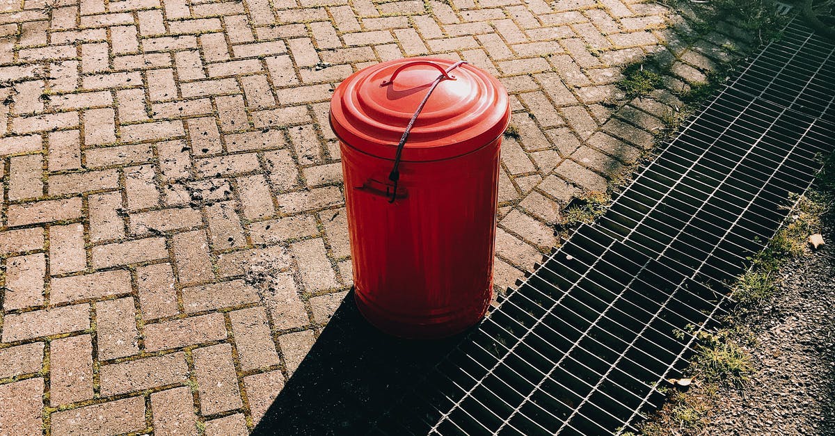 Can I bring an empty eggshell into Australia? - High angle of red metal trash can placed on pavement near sewer grates in city street in sunny summer day Can I bring an empty eggshell into Australia? - High angle of red metal trash can placed on pavement near sewer grates in city street in sunny summer day