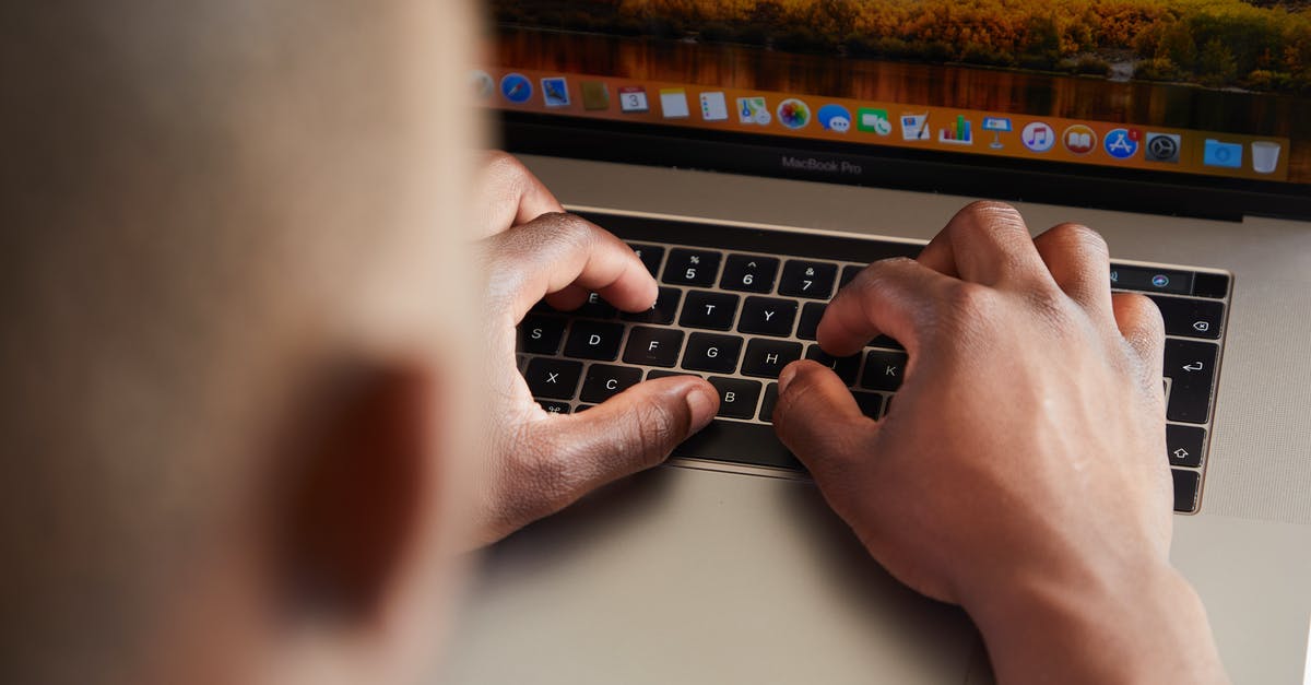 Can I bring my desktop computer as check-in baggage on a flight? [duplicate] - From above of crop anonymous busy African American male typing on keyboard of contemporary netbook