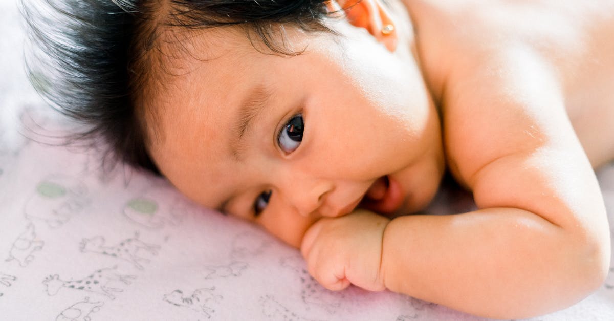Can I buy a child ticket for my infant baby? - Baby Lying on White and Pink Floral Textile Can I buy a child ticket for my infant baby? - Baby Lying on White and Pink Floral Textile