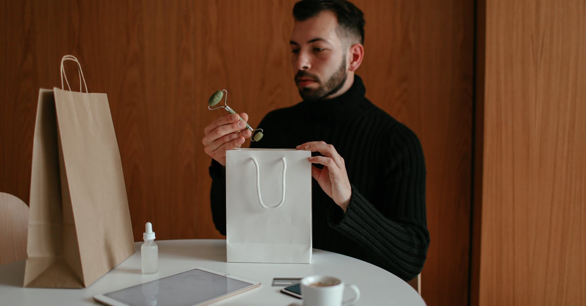 Can I carry my makeup like kajal eyeliner hair serum on my check in bags? - Stylish man unpacking shopping bag with beauty products ordered with credit card Can I carry my makeup like kajal eyeliner hair serum on my check in bags? - Stylish man unpacking shopping bag with beauty products ordered with credit card