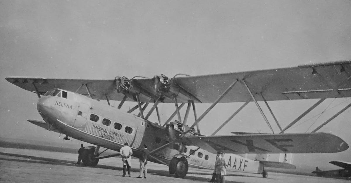 Can I check in the day before when flying British Airways from Geneva to London? - Grayscale Photo of Airplane on the Ground With Men Looking