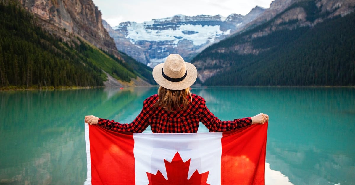 Can I come back to Canada with an expired passport? - Woman Wearing Red and Black Checkered Dress Shirt and Beige Fedora Hat Holding Canada Flag Looking at Lake Can I come back to Canada with an expired passport? - Woman Wearing Red and Black Checkered Dress Shirt and Beige Fedora Hat Holding Canada Flag Looking at Lake