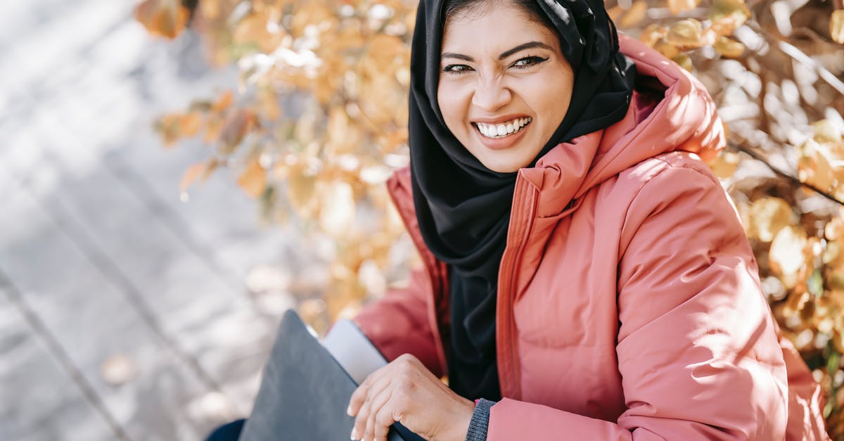 Can I communicate via an encrypted connection in United Arab Emirates? - Delightful ethnic woman with laptop in park Can I communicate via an encrypted connection in United Arab Emirates? - Delightful ethnic woman with laptop in park