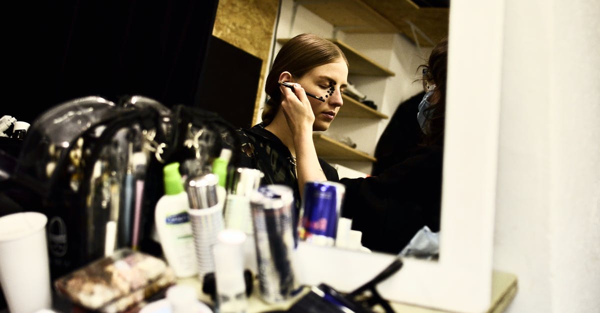 Can I correct an error on a visa application? [duplicate] - Reflection of female visagiste with brush applying makeup on face of model in dressing room
