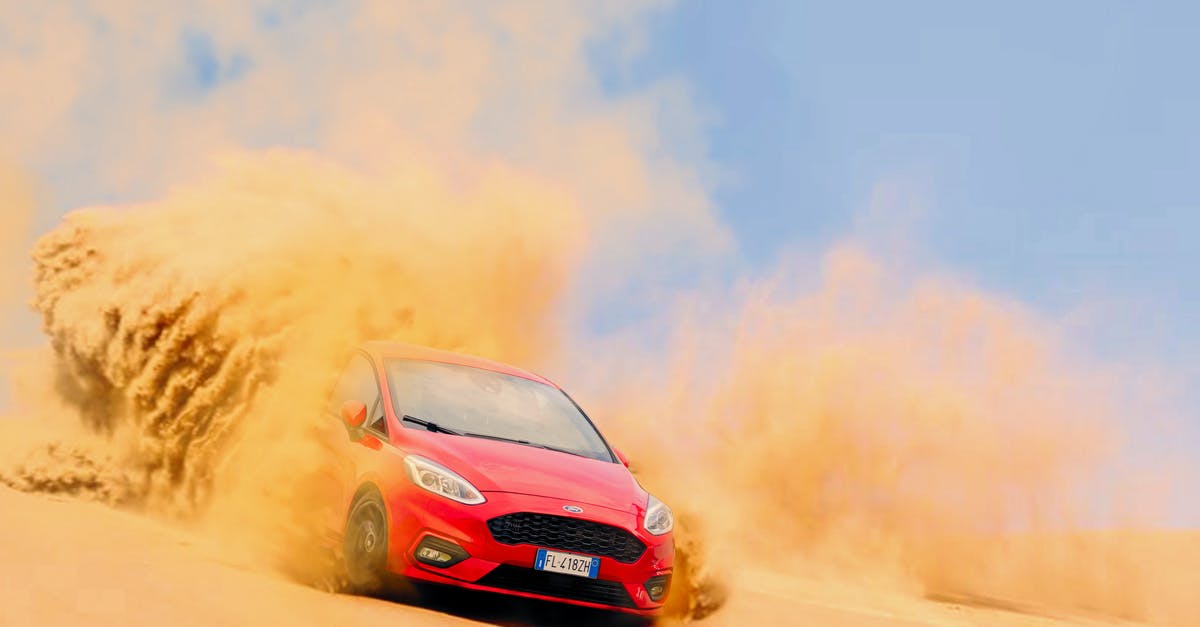 Can I drive my Spanish REG 1989 Ford Escort in the Netherlands? - Red Ford Focus Vehicle Driving on Sand Under Blue Daytime Sky