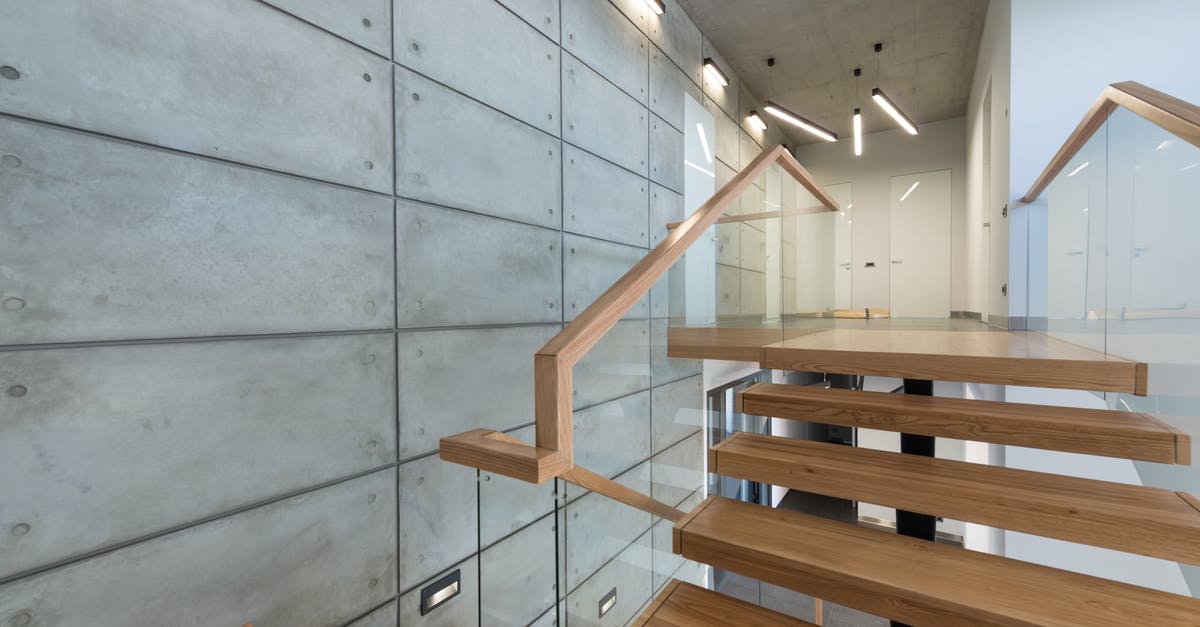 Can I enter Canada with previous entry denial into another country? - Wooden staircase with glass banister in house