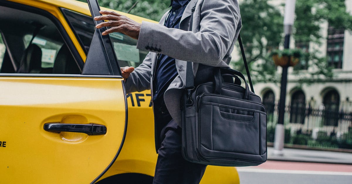 Can I enter France via Switzerland (and then get a cab to France) on the Schengen visa? [duplicate] - Side view of crop anonymous African American male opening door of bright yellow cab on street