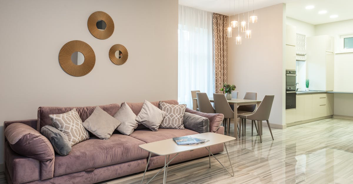 Can I enter Romania with a Polish Temporary Residence Card? [closed] - Modern interior design of flat with comfortable couch in stylish living room with kitchen equipped with built in appliances