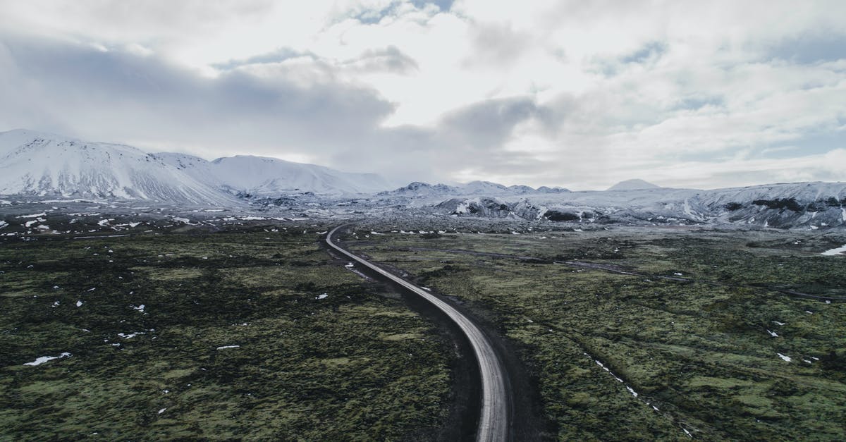 Can I expect "winter" scenery in Iceland in April? - Gray Asphalt Road Between Green Grass Field Under White Cloudy Sky Can I expect "winter" scenery in Iceland in April? - Gray Asphalt Road Between Green Grass Field Under White Cloudy Sky