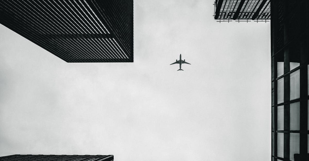 Can I fly via a third city on a second ticket? - Low Angle Photography of Airplane And Buildings Can I fly via a third city on a second ticket? - Low Angle Photography of Airplane And Buildings