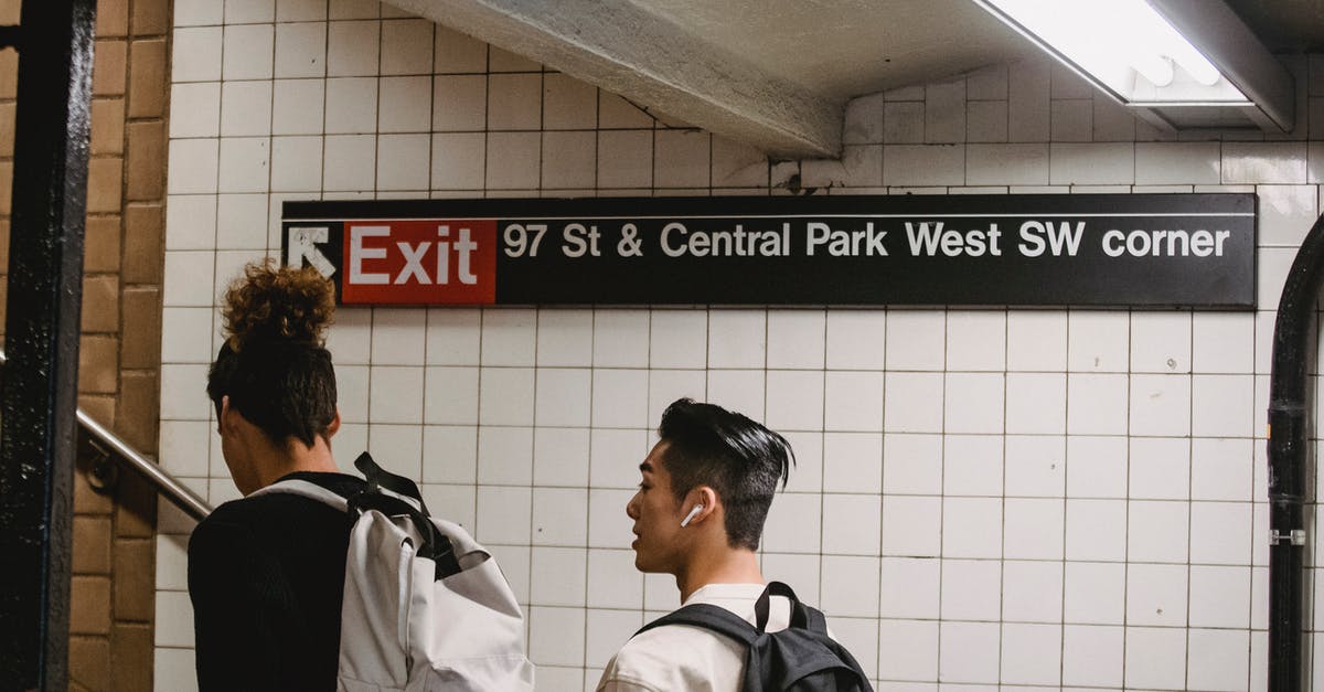 Can I get a transit visa in Taiwan on arrival? - Back view of ethnic male walking in subway station with friend while commuting to university Can I get a transit visa in Taiwan on arrival? - Back view of ethnic male walking in subway station with friend while commuting to university