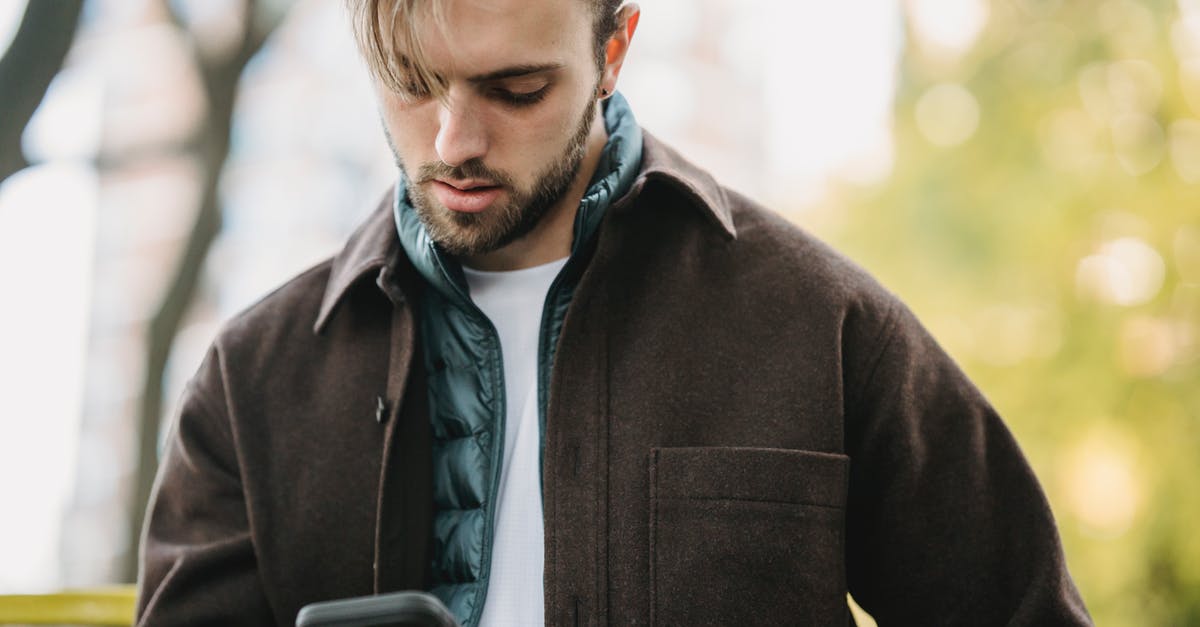 Can I get by using only Spanish in Oaxaca? - Young hipster looking at smartphone screen in park Can I get by using only Spanish in Oaxaca? - Young hipster looking at smartphone screen in park