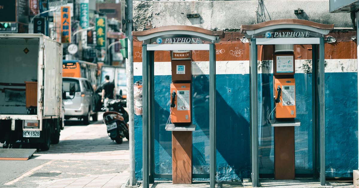 Can I get European-wide traffic predictions similar to the one from Paris? - Similar old phone booths near shabby wall and street road Can I get European-wide traffic predictions similar to the one from Paris? - Similar old phone booths near shabby wall and street road
