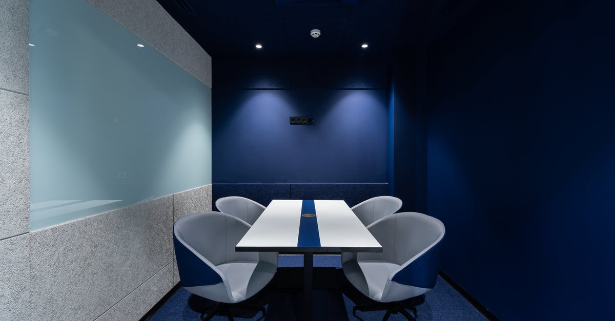 Can I go inside Lebanon during a long transit? - Comfortable chairs placed on carpet at long white desk in modern conference room with blue walls in contemporary business center Can I go inside Lebanon during a long transit? - Comfortable chairs placed on carpet at long white desk in modern conference room with blue walls in contemporary business center