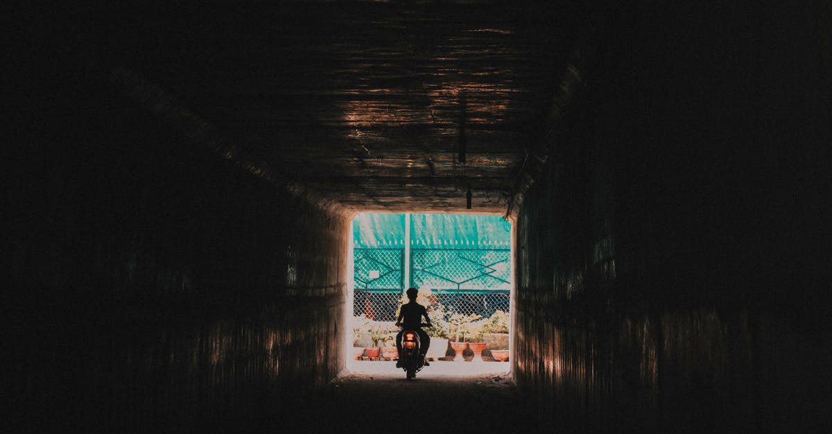 Can I go out of LA airport during a layover without a visa? [duplicate] - Person Riding a Motorcycle Going out from the Tunnel