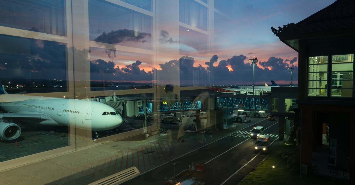 Can I go through transfers with separate tickets/airlines? - Through glass modern aircraft parked near airbridge in contemporary airport against picturesque dusk sky Can I go through transfers with separate tickets/airlines? - Through glass modern aircraft parked near airbridge in contemporary airport against picturesque dusk sky