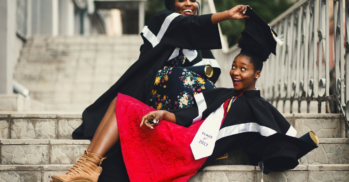 Can I have chance to have student Visa in the UK after my visa was annulled by Schengen? - Shallow Focus Photography of Two Women in Academic Dress on Flight of Stairs
