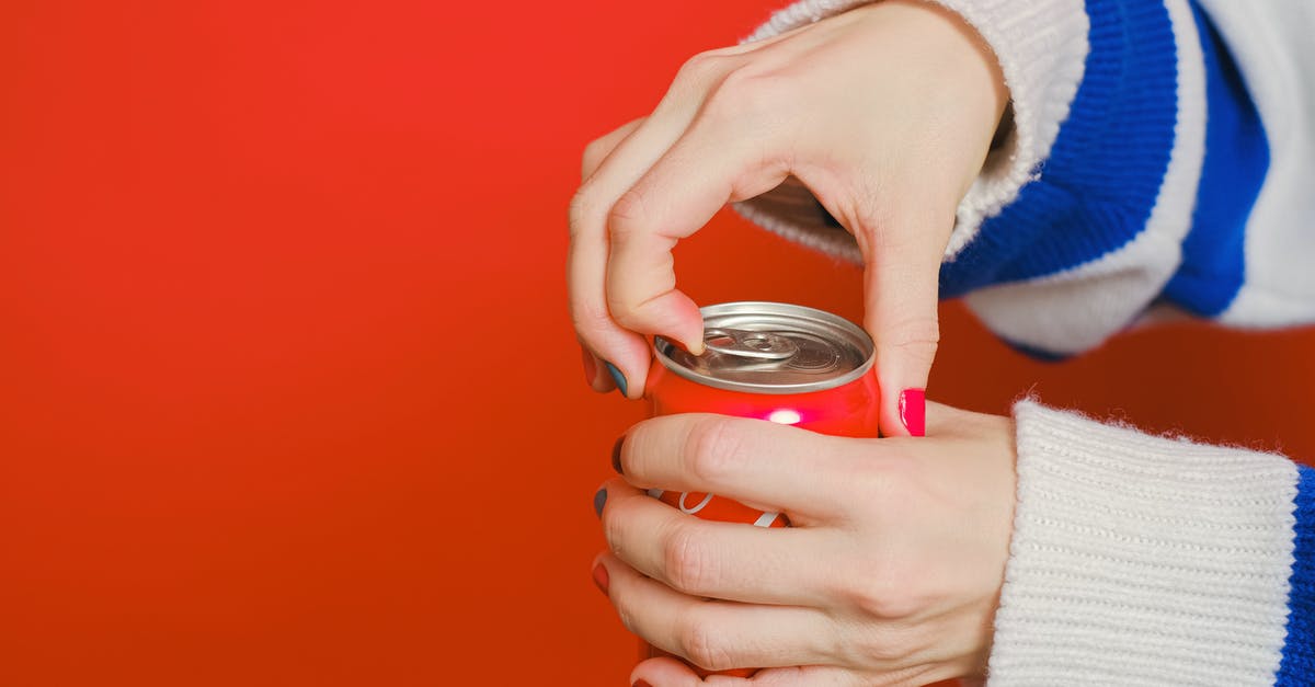 Can I import absinthe into Australia? - Person Holding Can With Blue and White Knit Sweater Can I import absinthe into Australia? - Person Holding Can With Blue and White Knit Sweater