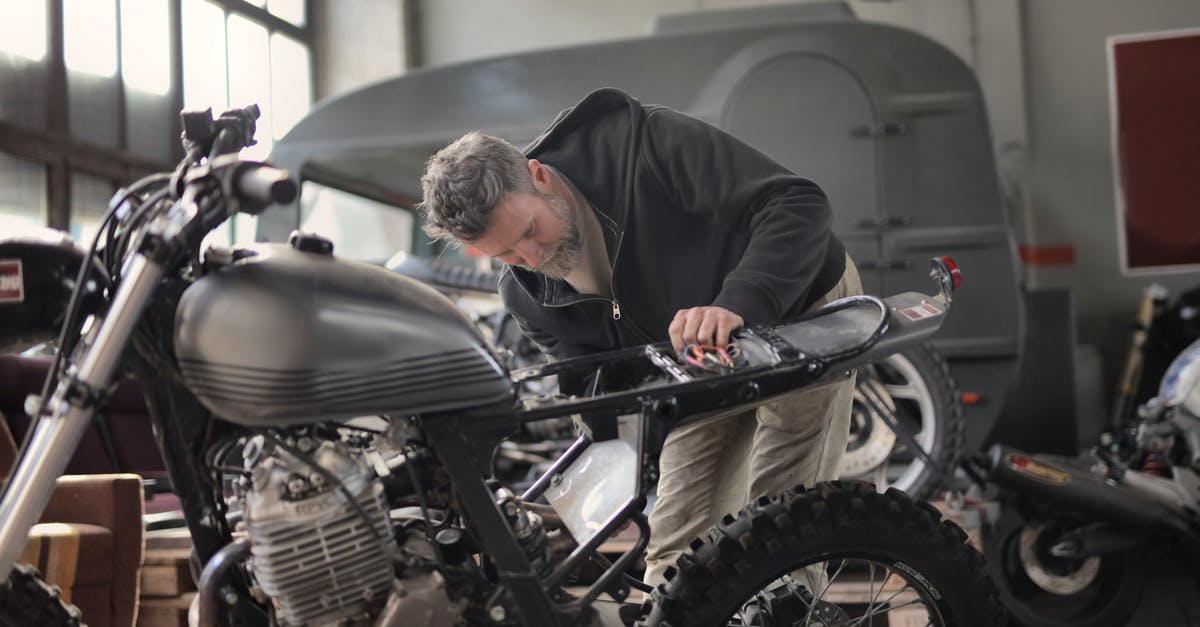 Can I invite my parents to the UK while changing jobs (I'm on a work visa here)? - Man in Black Jacket Inspecting a Motorcycle Can I invite my parents to the UK while changing jobs (I'm on a work visa here)? - Man in Black Jacket Inspecting a Motorcycle