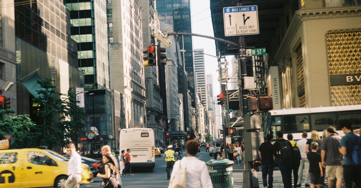 Can I leave the transit area during an EU+Schengen layover? - People walking in busy modern city Can I leave the transit area during an EU+Schengen layover? - People walking in busy modern city