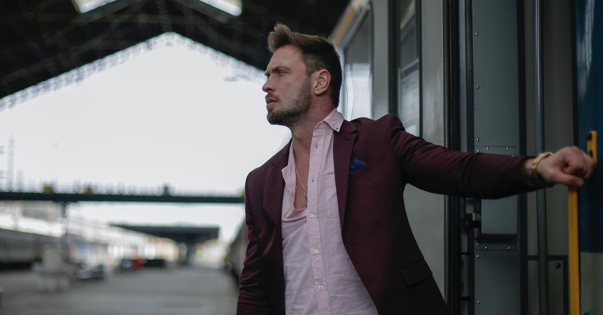 Can I leave the transit area during an EU+Schengen layover? - Confident adult businessman in formal outfit on platform of railway station Can I leave the transit area during an EU+Schengen layover? - Confident adult businessman in formal outfit on platform of railway station
