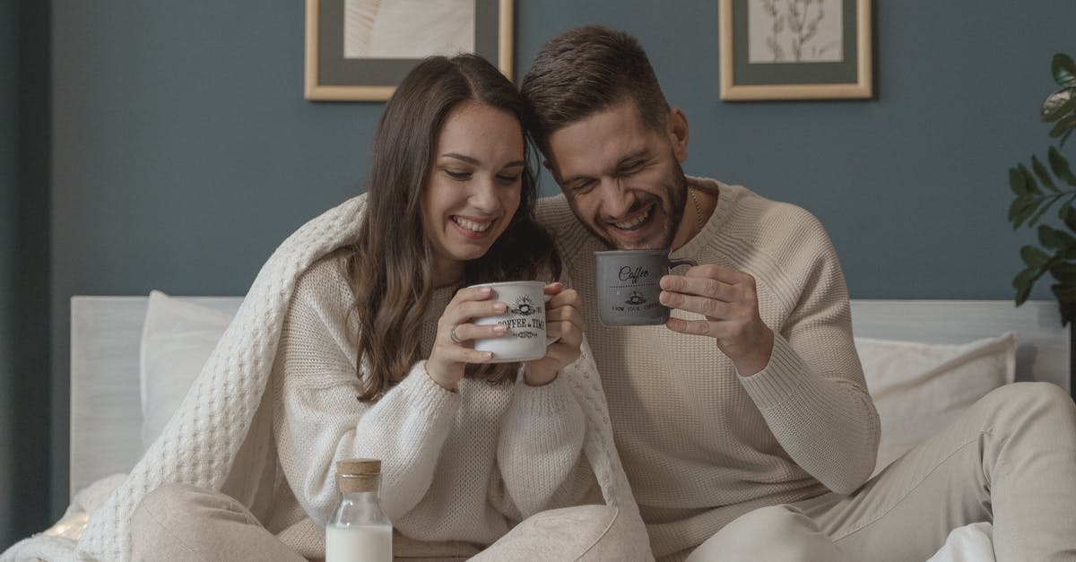 Can I leave the UK for a few days without my wife (she has an EEA Family Visa)? [closed] - Couple Smiling while Having Their Breakfast in Bed